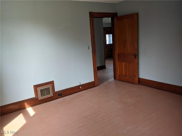 unfurnished room featuring hardwood / wood-style floors