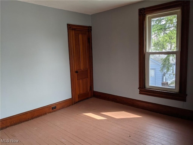 spare room with light wood-type flooring