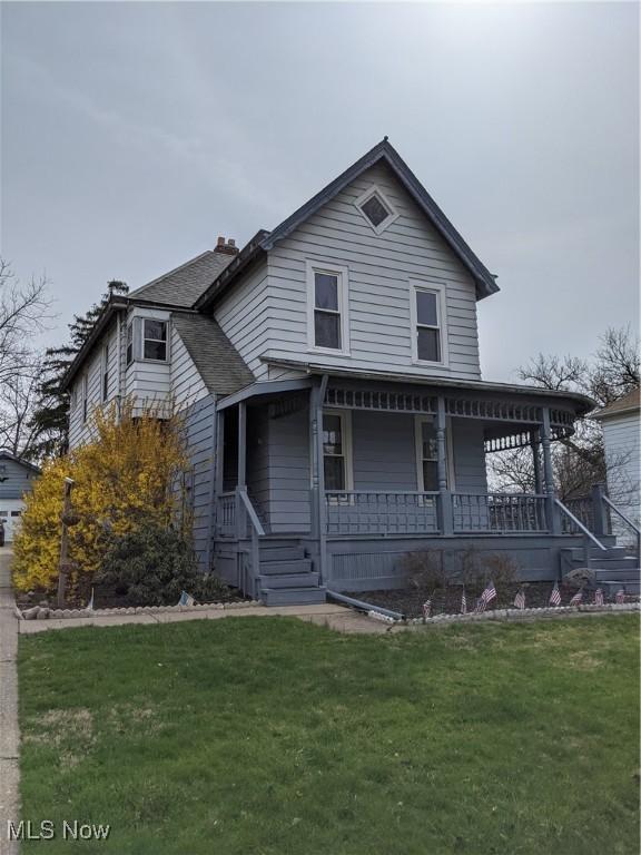 view of front of property with covered porch and a front yard