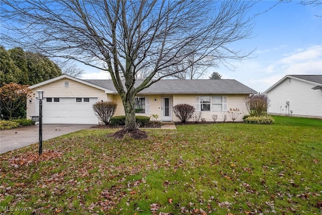 ranch-style home with a garage and a front yard