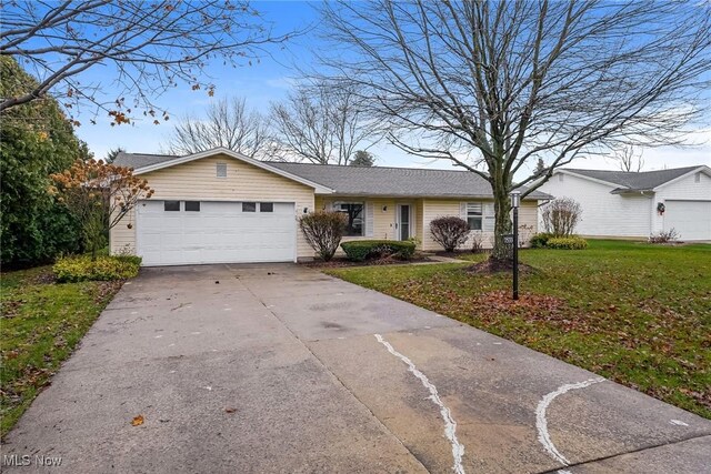 single story home with a garage and a front yard