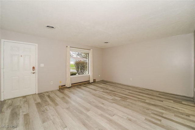 interior space featuring light wood-type flooring and baseboard heating