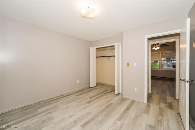 unfurnished bedroom with light hardwood / wood-style floors and a closet