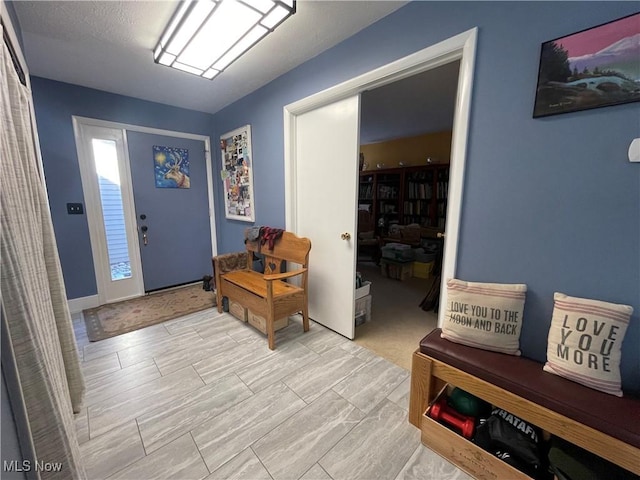 entryway with a textured ceiling