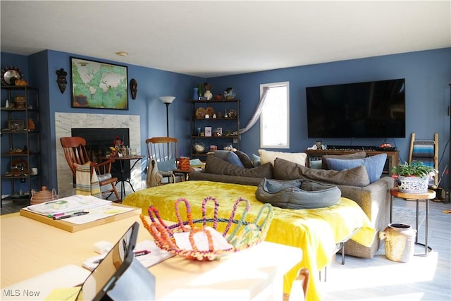 bedroom featuring hardwood / wood-style floors and a fireplace