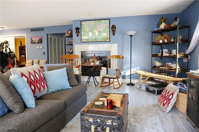 living room featuring a fireplace and light hardwood / wood-style flooring