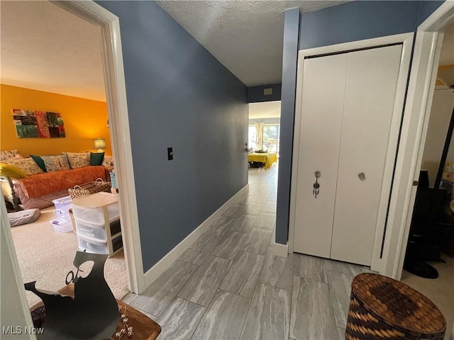 hallway featuring a textured ceiling