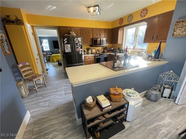 kitchen featuring kitchen peninsula and appliances with stainless steel finishes