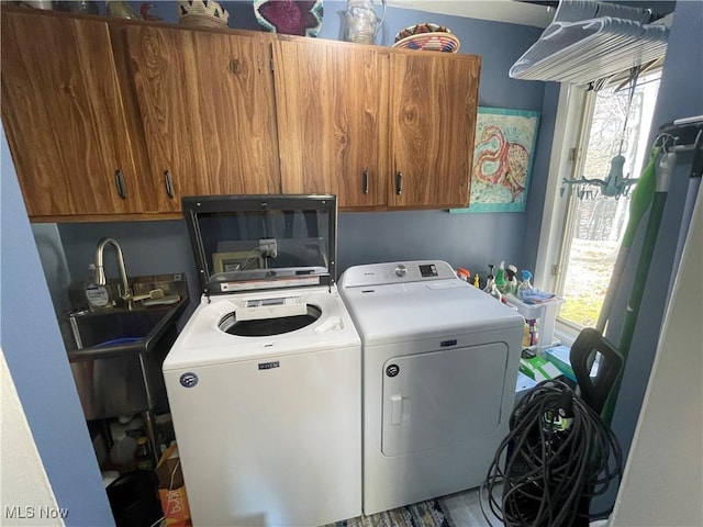 laundry room with cabinets and washing machine and clothes dryer