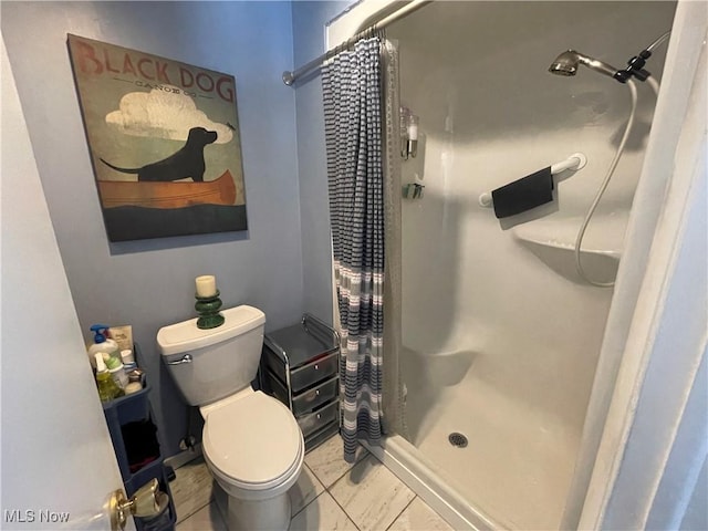 bathroom with a shower with curtain and toilet