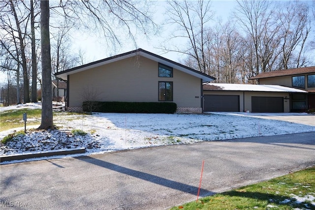 view of snow covered exterior with a garage