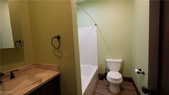 bathroom with hardwood / wood-style flooring, vanity, and toilet