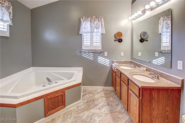 bathroom with a tub, plenty of natural light, and vanity