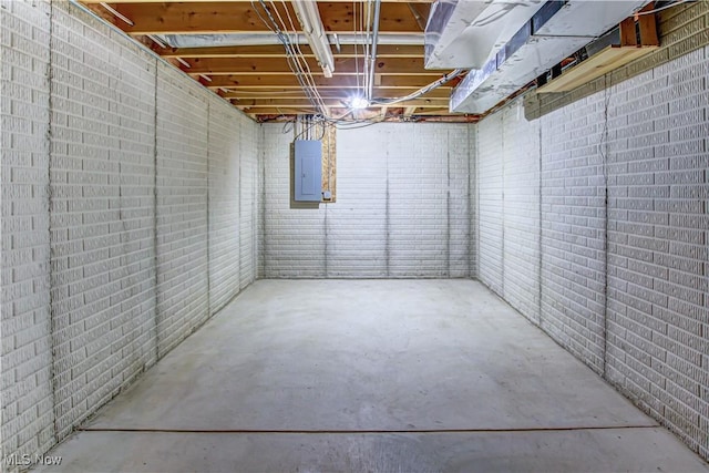 basement with brick wall and electric panel