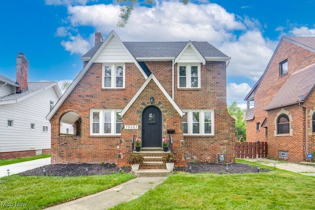 english style home with a front yard