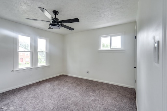 unfurnished room with carpet flooring, a wealth of natural light, and ceiling fan