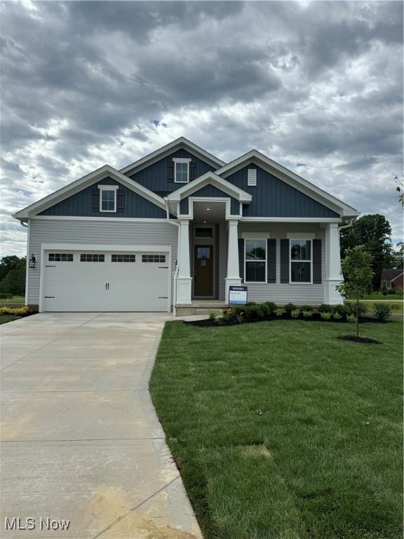 craftsman-style home with a garage and a front lawn