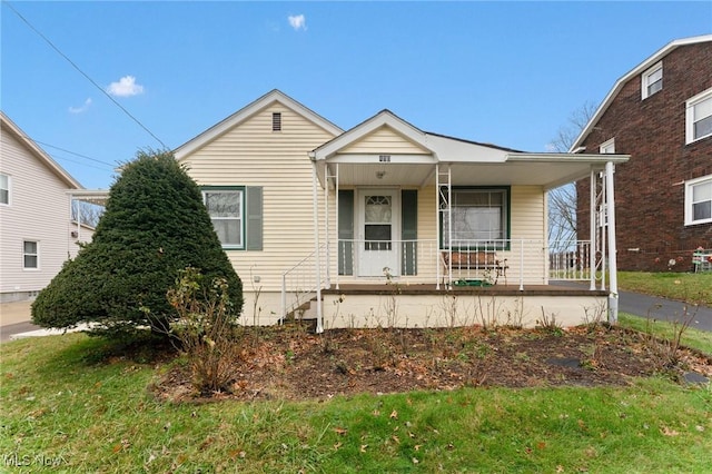 bungalow featuring a porch and a front yard