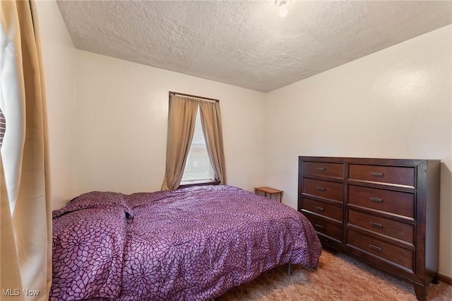 bedroom with carpet flooring and a textured ceiling