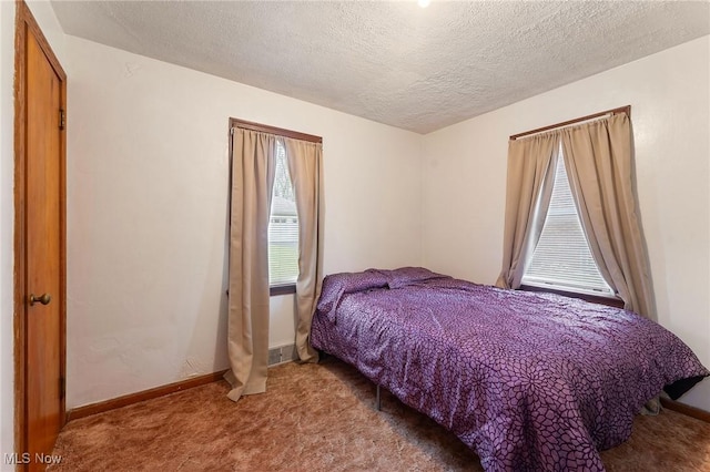 bedroom with carpet and a textured ceiling