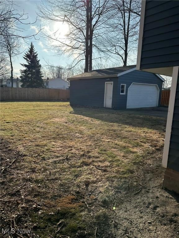 view of yard featuring an outbuilding and a garage