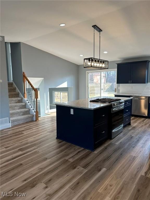 kitchen featuring plenty of natural light, a kitchen island, and appliances with stainless steel finishes