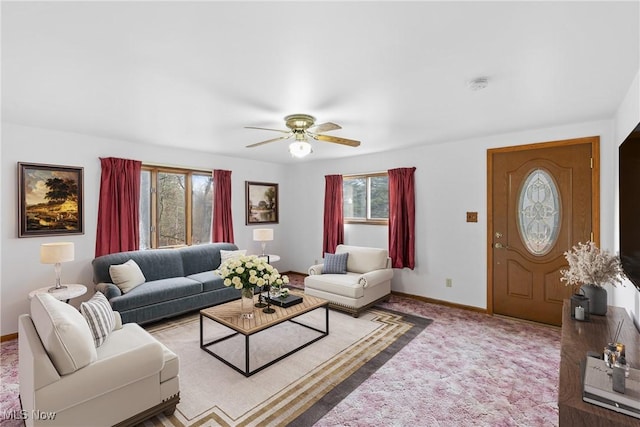 carpeted living room with ceiling fan