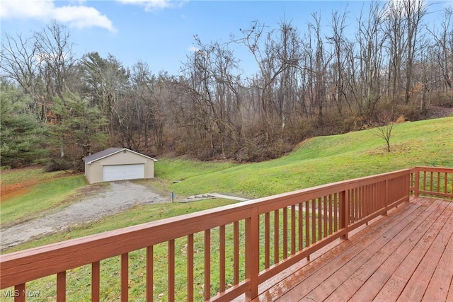 deck featuring a lawn, a garage, and an outdoor structure