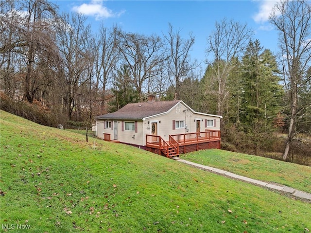 exterior space with a deck and a front yard