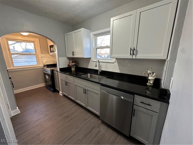 kitchen featuring white cabinets, appliances with stainless steel finishes, plenty of natural light, and sink