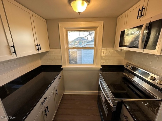 kitchen featuring white cabinets, decorative backsplash, stainless steel appliances, and dark hardwood / wood-style floors