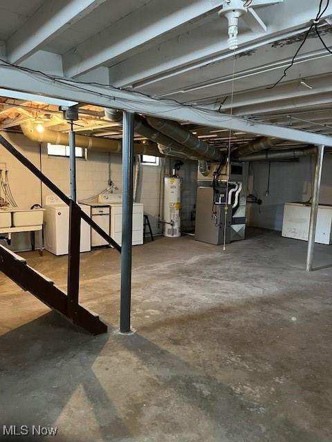 basement with washer and dryer, gas water heater, and heating unit