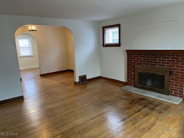 unfurnished living room featuring dark hardwood / wood-style floors