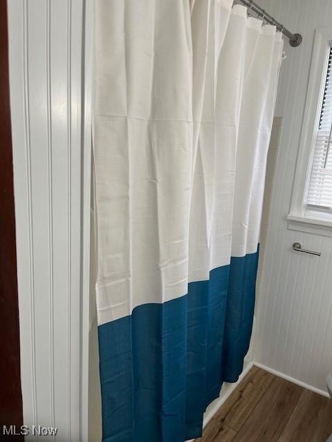 bathroom with hardwood / wood-style floors and a shower with curtain