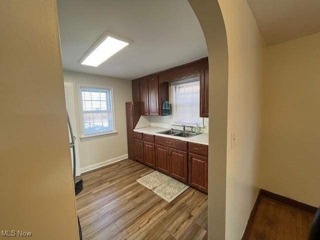 kitchen with light hardwood / wood-style flooring and sink