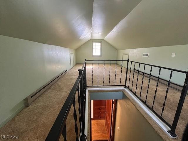 stairs with vaulted ceiling, carpet floors, and a baseboard radiator