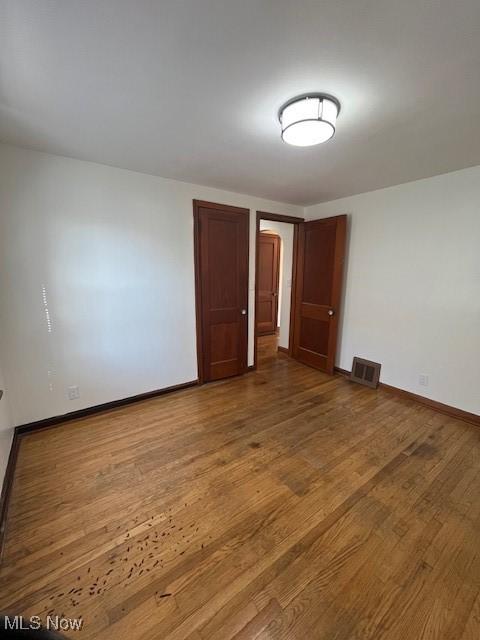 unfurnished room featuring hardwood / wood-style floors