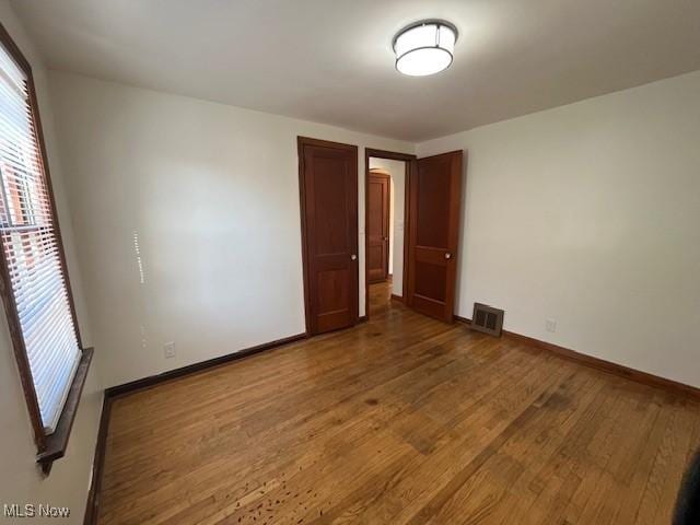 unfurnished bedroom with hardwood / wood-style flooring