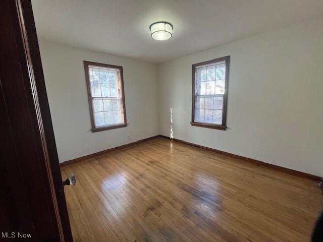 empty room featuring hardwood / wood-style floors and a healthy amount of sunlight