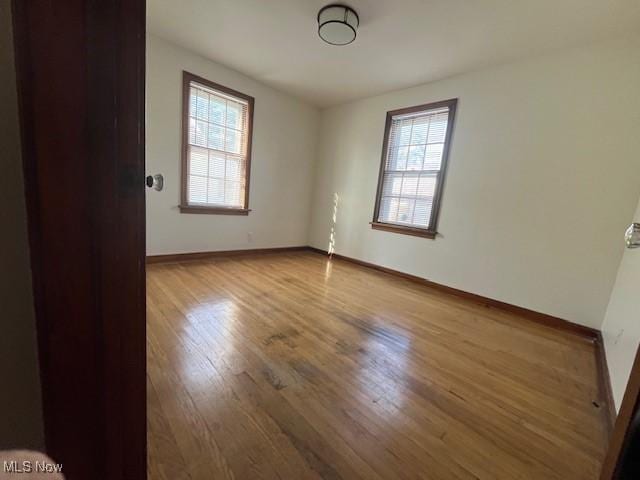 empty room with wood-type flooring