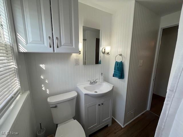 bathroom featuring hardwood / wood-style floors, vanity, and toilet