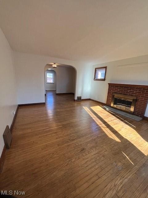 unfurnished living room with a fireplace and dark hardwood / wood-style floors