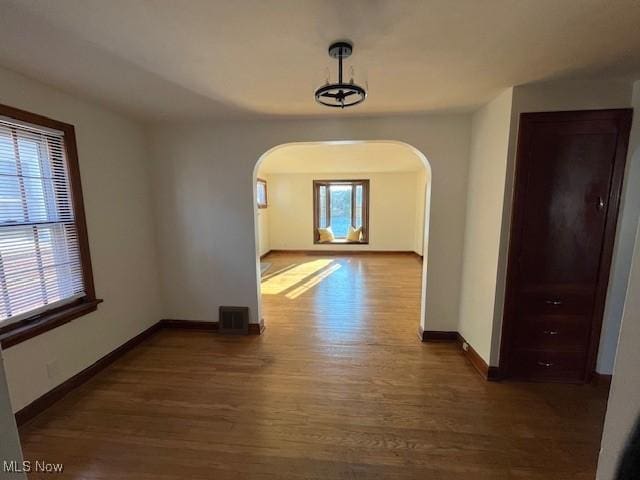 unfurnished dining area with dark hardwood / wood-style flooring and a wealth of natural light