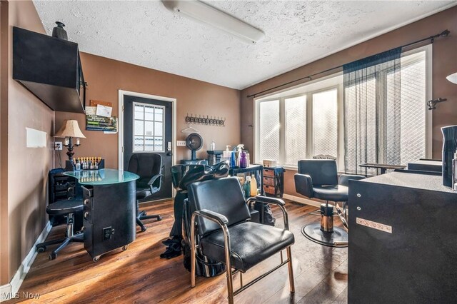 home office with hardwood / wood-style floors and a textured ceiling