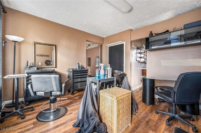 office with hardwood / wood-style floors and a textured ceiling