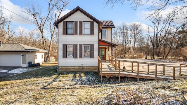 exterior space with a garage and a wooden deck