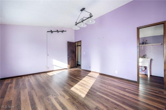 unfurnished room with dark hardwood / wood-style flooring, sink, and high vaulted ceiling