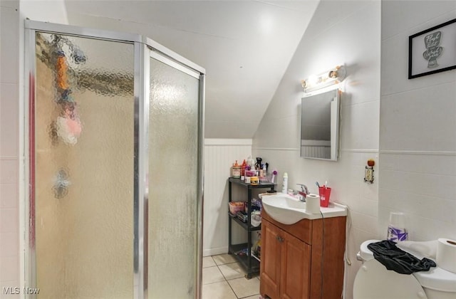 bathroom with vanity, tile patterned flooring, lofted ceiling, toilet, and a shower with shower door