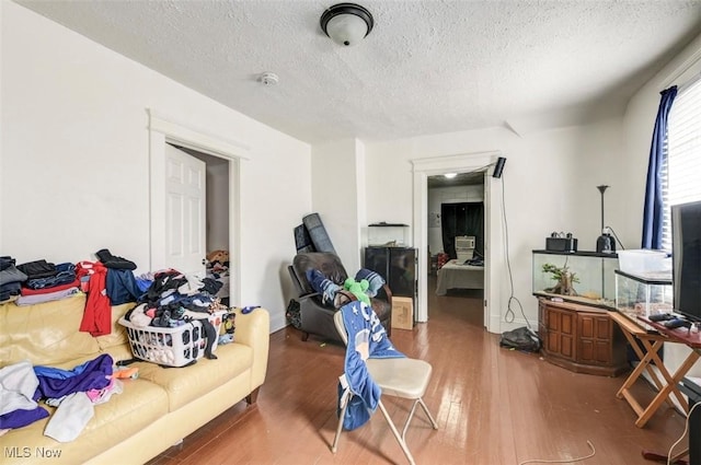 living room featuring hardwood / wood-style floors and a textured ceiling