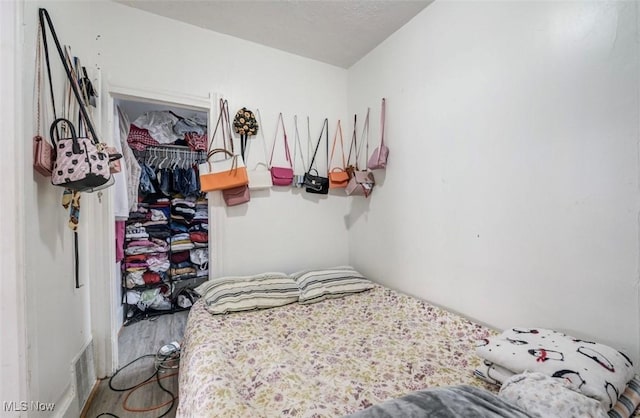 bedroom with hardwood / wood-style floors